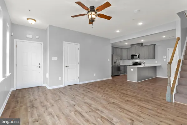 a view of a kitchen with a sink and a refrigerator