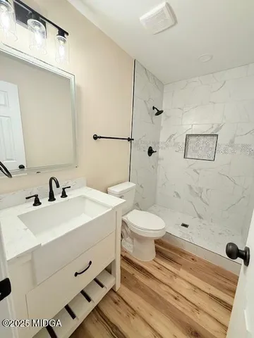 a bathroom with a toilet and a shower