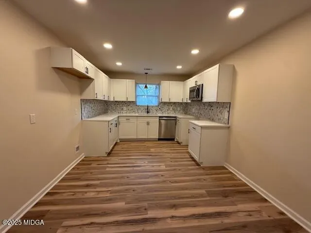 a view of a room with wooden floor and staircase