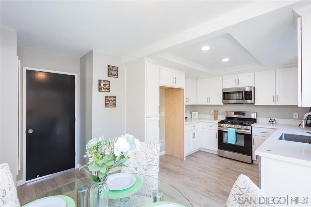 265 Argus Way Oceanside, CA 92057 - Photo 11 of 24 a kitchen with stainless steel appliances granite countertop a refrigerator stove microwave and sink