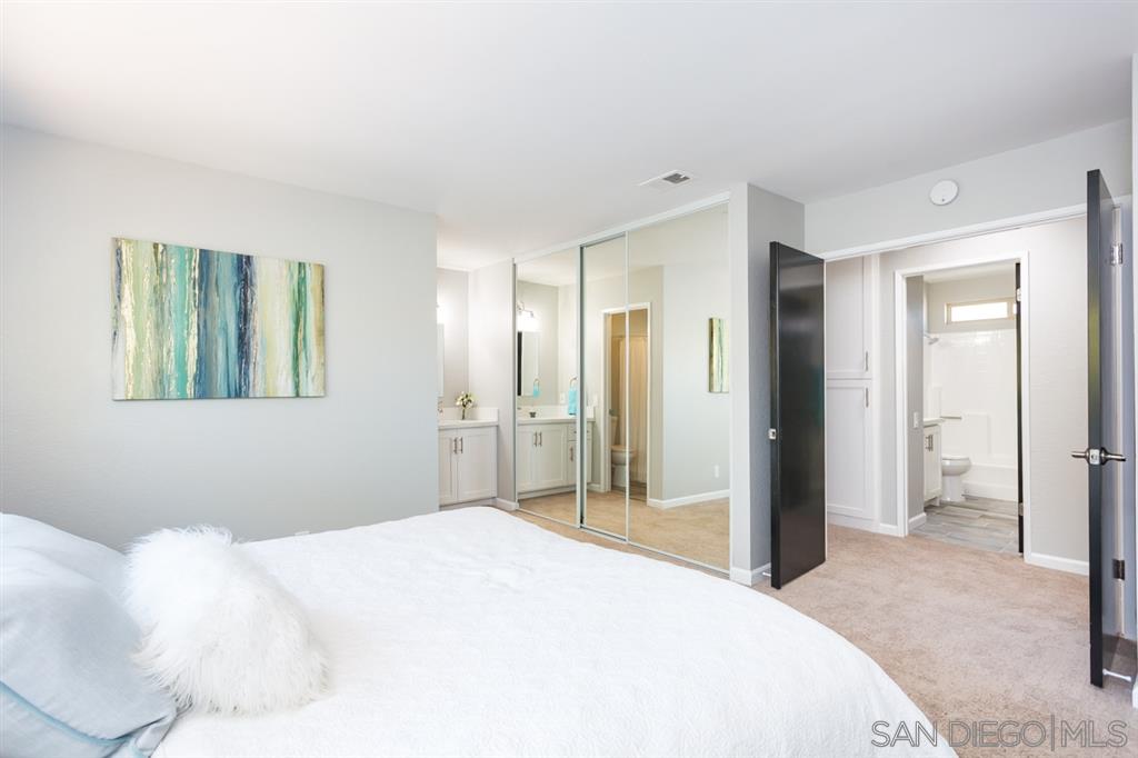 265 Argus Way Oceanside, CA 92057 - Photo 16 of 24 a bedroom with a bed and a mirror