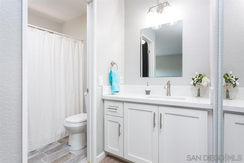 265 Argus Way Oceanside, CA 92057 - Photo 17 of 24 a bathroom with a sink and a mirror