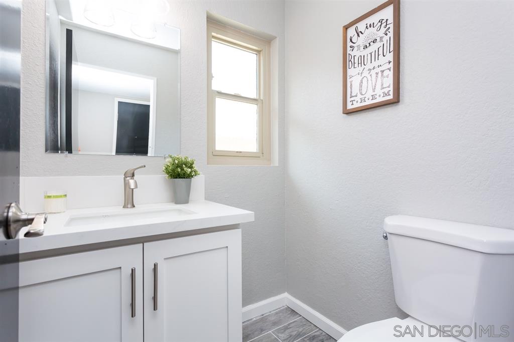265 Argus Way Oceanside, CA 92057 - Photo 20 of 24 a bathroom with a toilet sink and mirror