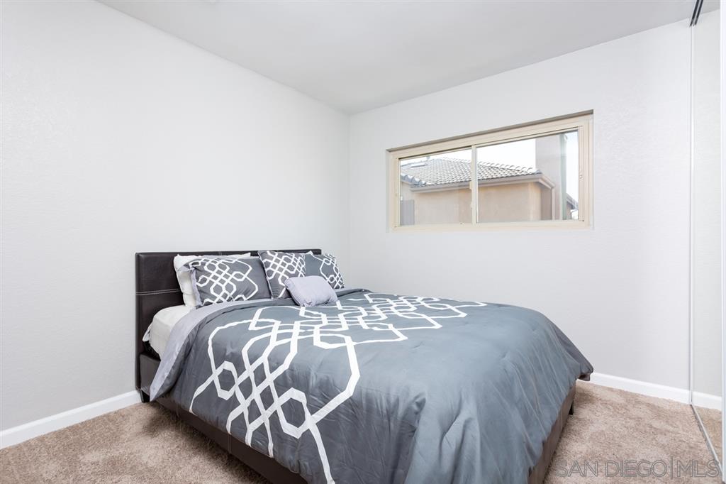 265 Argus Way Oceanside, CA 92057 - Photo 21 of 24 a bed sitting in a bedroom next to a window
