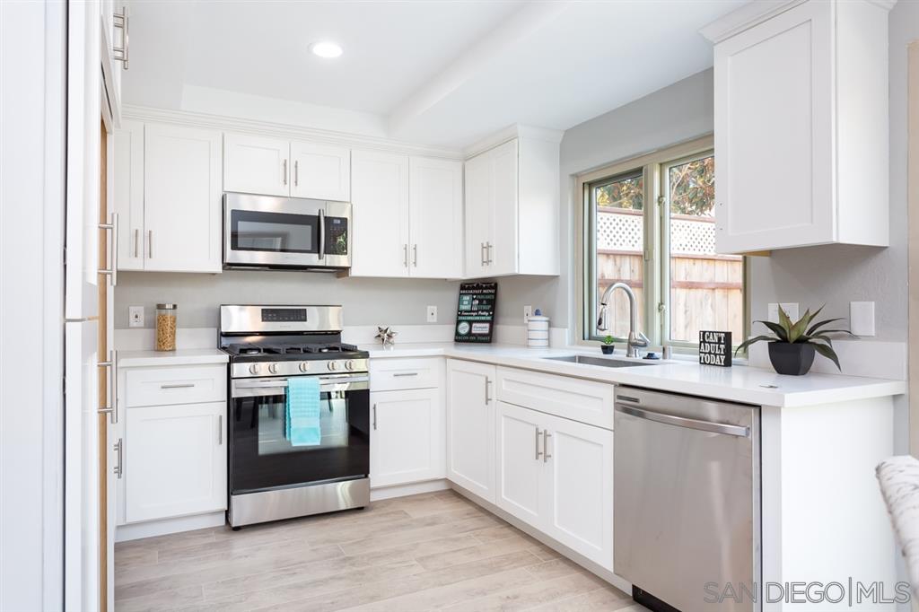 265 Argus Way Oceanside, CA 92057 - Photo 8 of 24 a kitchen with cabinets stainless steel appliances a sink and a window