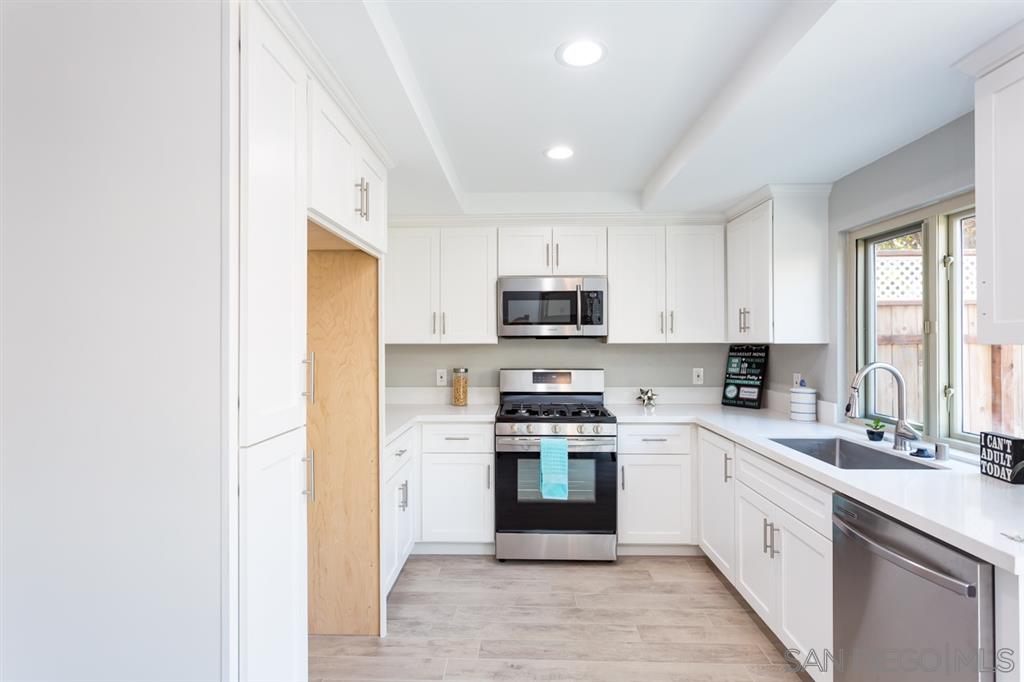 265 Argus Way Oceanside, CA 92057 - Photo 9 of 24 a kitchen with stainless steel appliances granite countertop a stove a sink and a refrigerator
