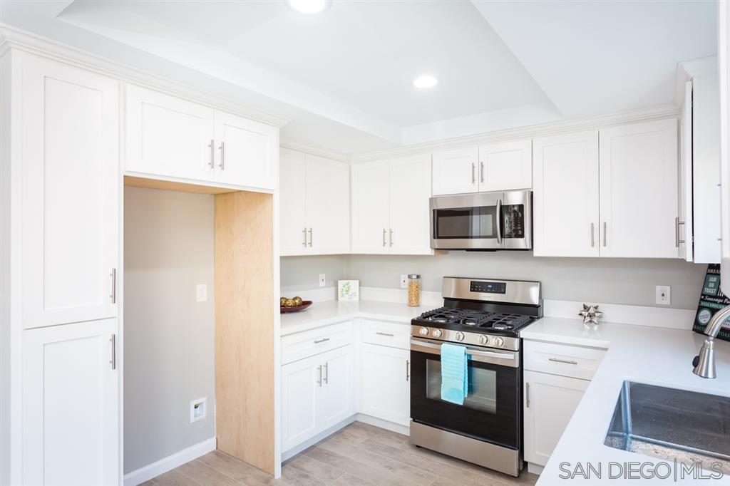 265 Argus Way Oceanside, CA 92057 - Photo 10 of 24 a kitchen with stainless steel appliances white cabinets and a sink