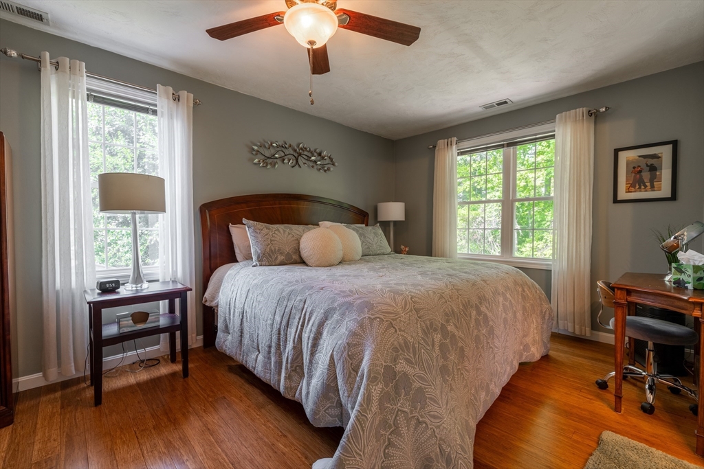 22 Duluth Street Worcester, MA 01604 - Photo 25 of 35 a bedroom with a bed a chandelier and a window