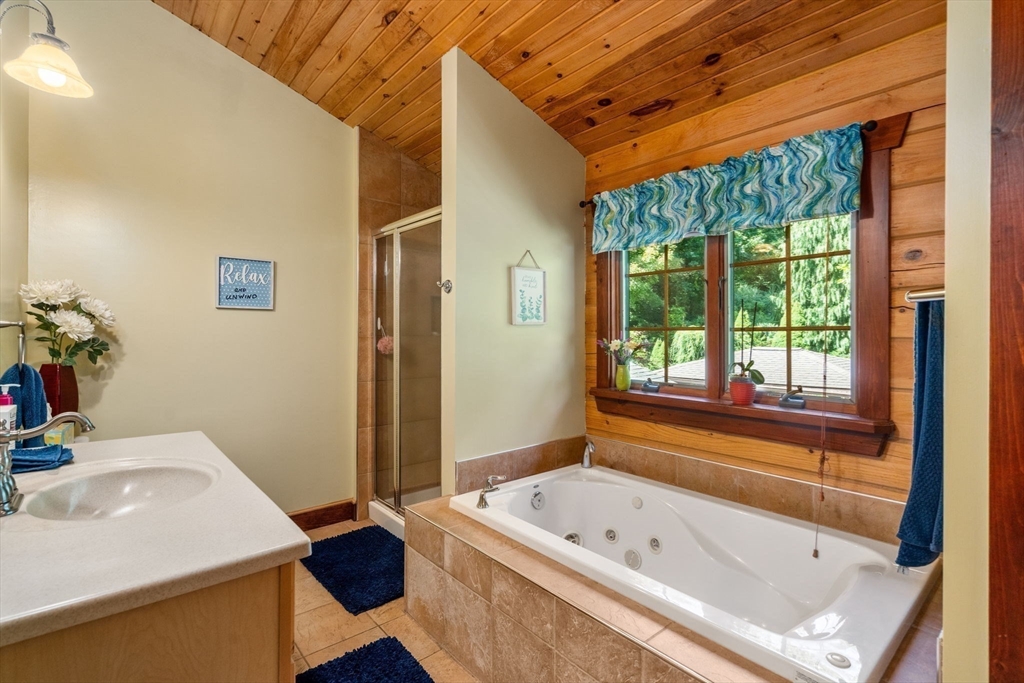 67 Streeter Road Sturbridge, MA 01518 - Photo 20 of 41 a bathroom with a tub and a sink