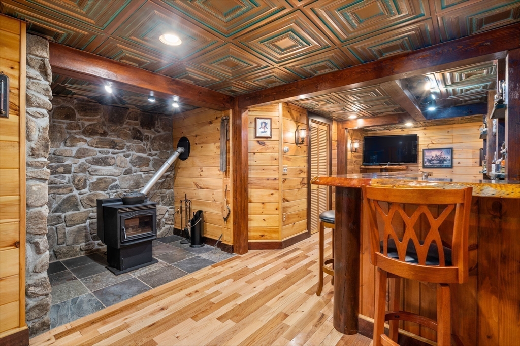 67 Streeter Road Sturbridge, MA 01518 - Photo 27 of 41 a view of a fireplace with wooden floor