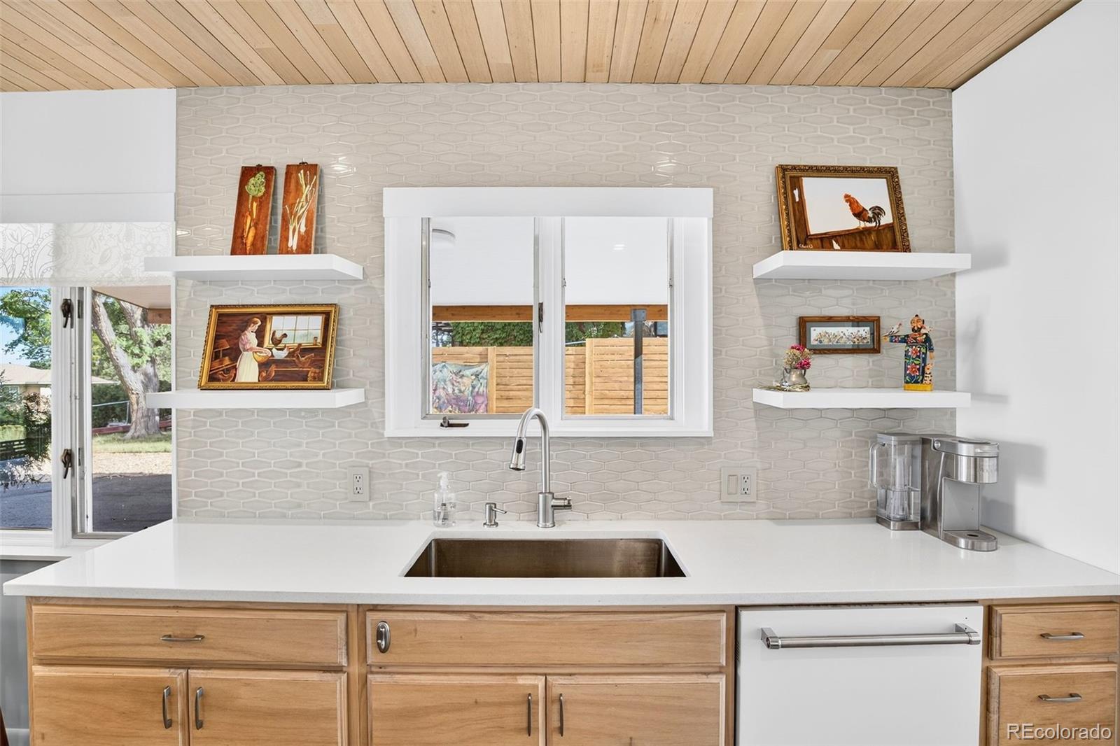 52 Hillside Drive Wheat Ridge, CO 80215 - Photo 12 of 48 a kitchen with a sink and a stove top oven