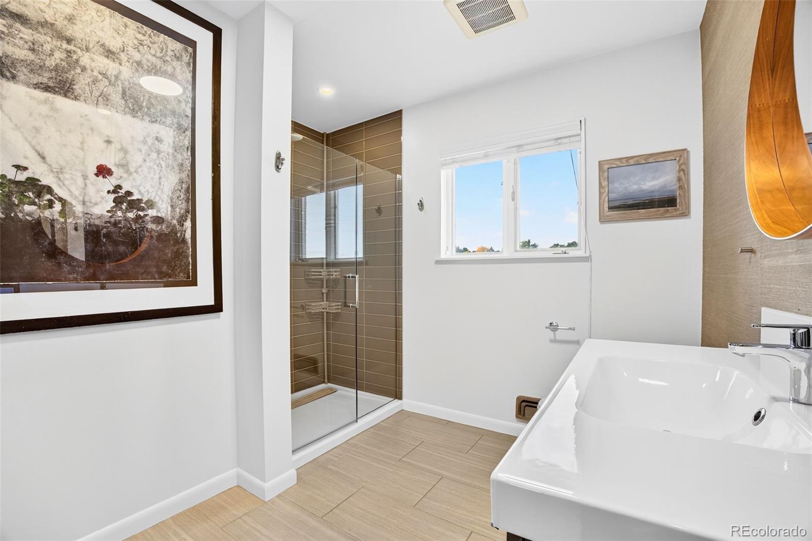 52 Hillside Drive Wheat Ridge, CO 80215 - Photo 20 of 48 a bathroom with a tub and shower