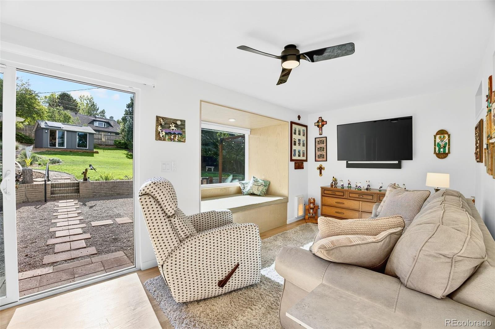 52 Hillside Drive Wheat Ridge, CO 80215 - Photo 24 of 48 a living room with furniture and a flat screen tv