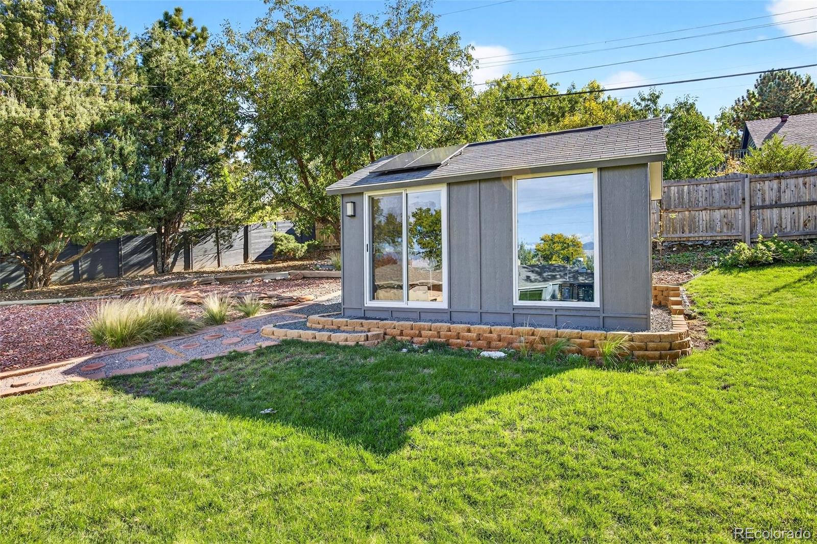 52 Hillside Drive Wheat Ridge, CO 80215 - Photo 28 of 48 a view of a house with backyard and sitting area