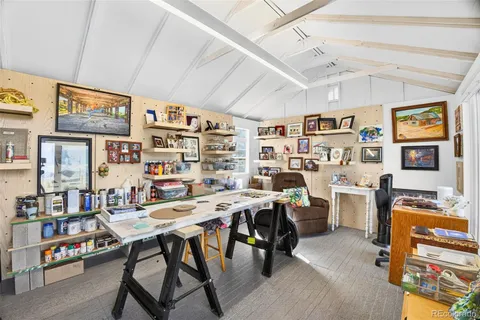 a view of a workspace with furniture and toys