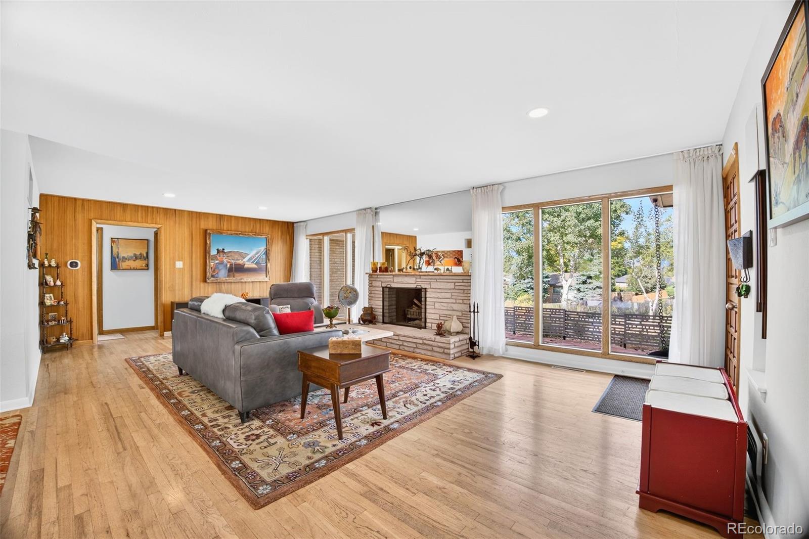 52 Hillside Drive Wheat Ridge, CO 80215 - Photo 3 of 48 a living room with furniture large window and wooden floor