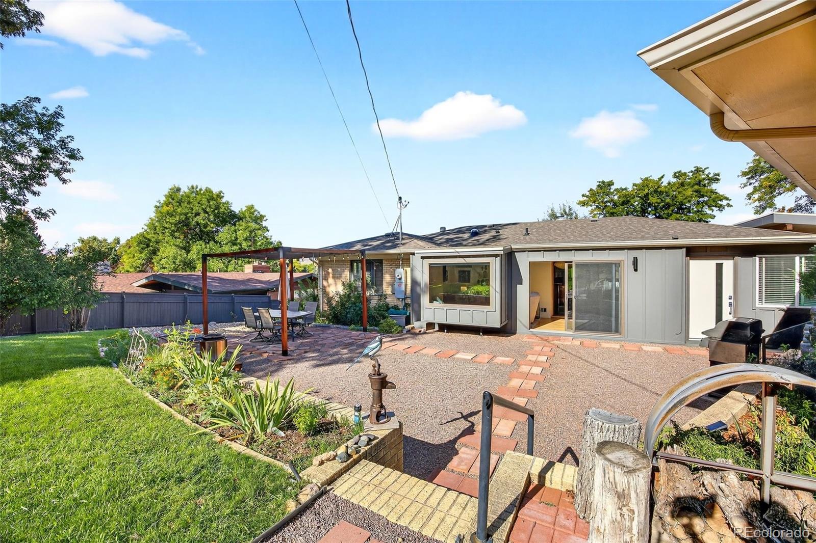 52 Hillside Drive Wheat Ridge, CO 80215 - Photo 31 of 48 a view of a patio with table and chairs potted plants with wooden fence
