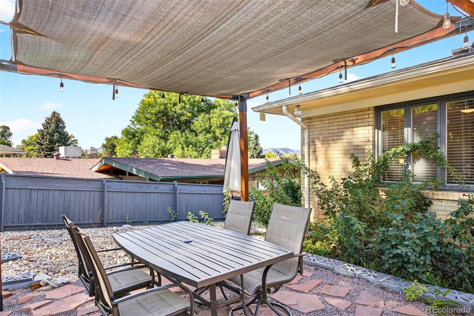 52 Hillside Drive Wheat Ridge, CO 80215 - Photo 33 of 48 a view of a table and chairs in patio
