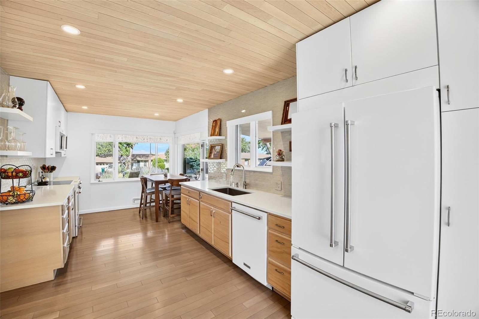 52 Hillside Drive Wheat Ridge, CO 80215 - Photo 8 of 48 a kitchen with white cabinets and stainless steel appliances