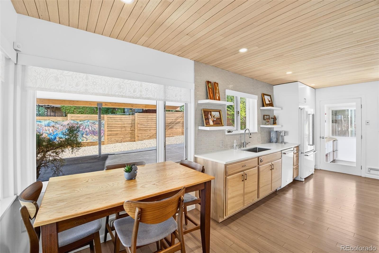 52 Hillside Drive Wheat Ridge, CO 80215 - Photo 9 of 48 a kitchen with a table chairs stove and wooden floor