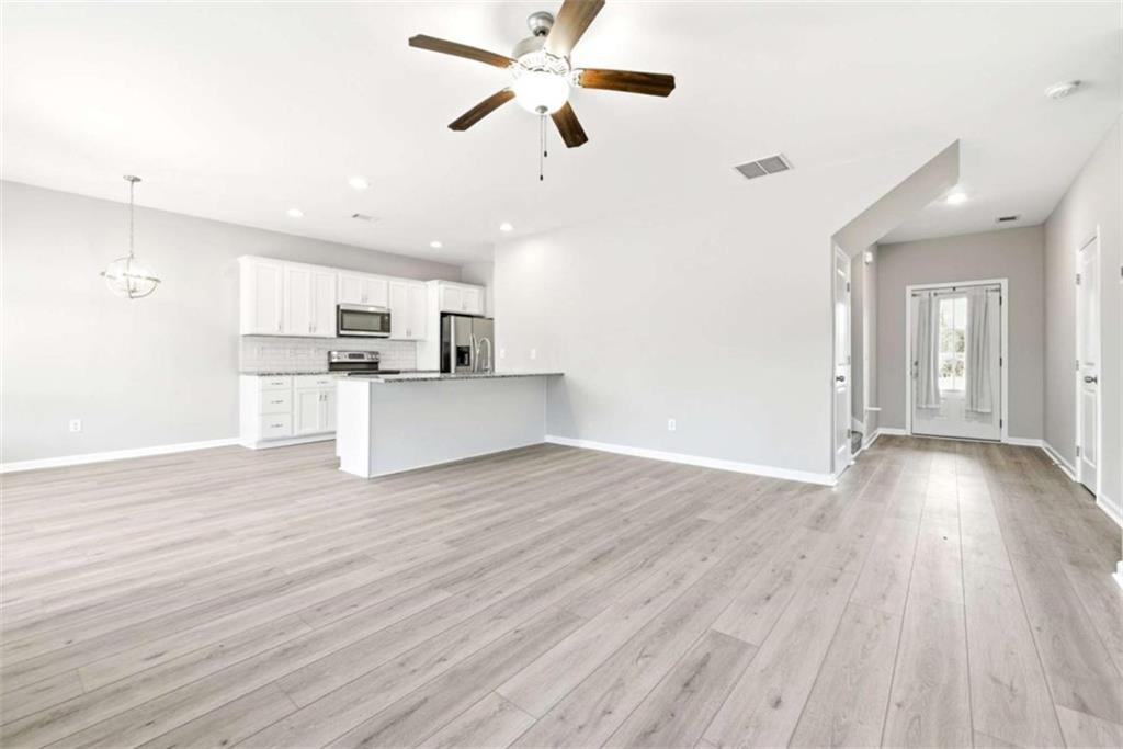 2066 Highway 63 Homer, GA 30547 - Photo 12 of 65 a view of a kitchen with wooden floor and a ceiling fan