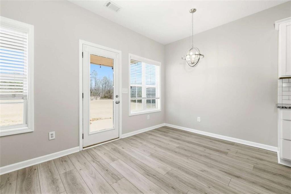 2066 Highway 63 Homer, GA 30547 - Photo 13 of 65 a view of an empty room with wooden floor and a window