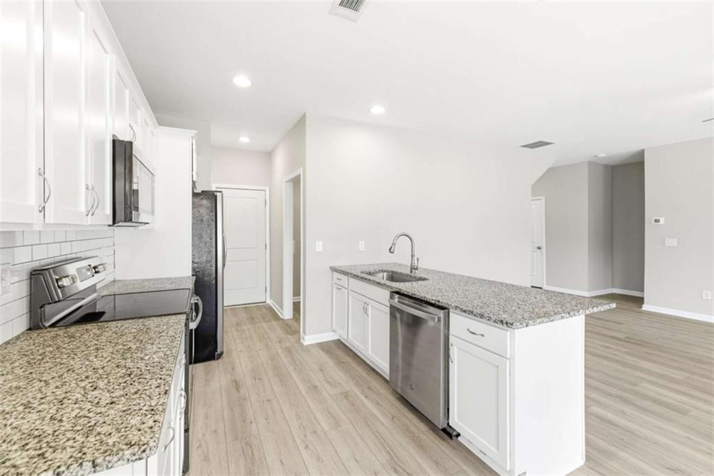 2066 Highway 63 Homer, GA 30547 - Photo 15 of 65 a kitchen with stainless steel appliances granite countertop a sink stove and refrigerator