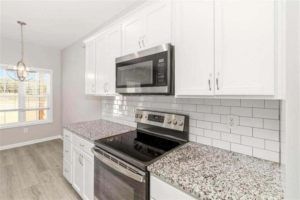 2066 Highway 63 Homer, GA 30547 - Photo 16 of 65 a kitchen with granite countertop a stove sink and microwave