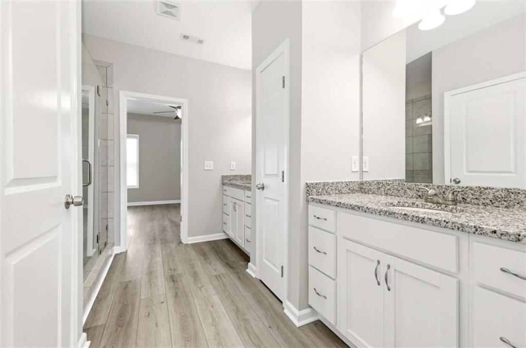 2066 Highway 63 Homer, GA 30547 - Photo 23 of 65 a bathroom with a granite countertop sink and a white cabinets
