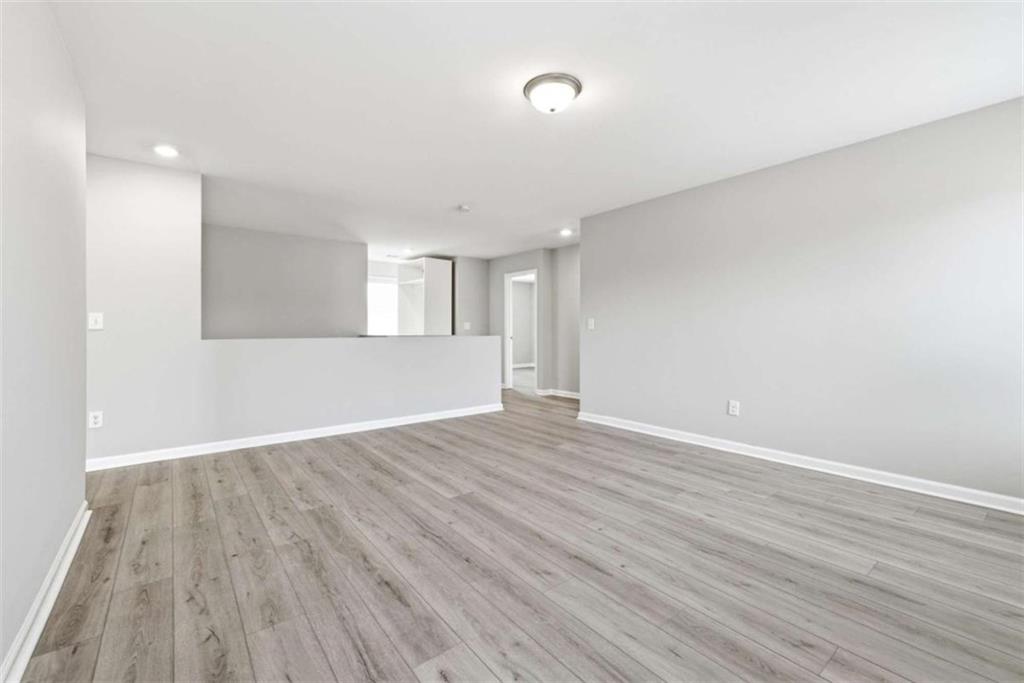 2066 Highway 63 Homer, GA 30547 - Photo 29 of 65 an empty room with wooden floor and windows