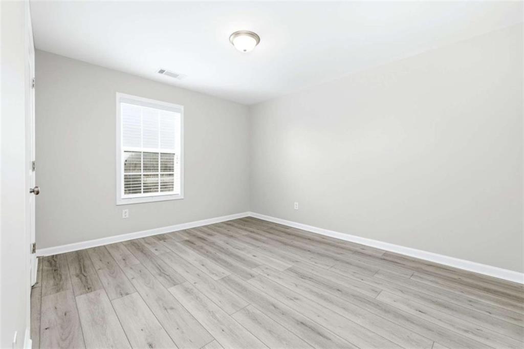 2066 Highway 63 Homer, GA 30547 - Photo 33 of 65 an empty room with wooden floor and windows