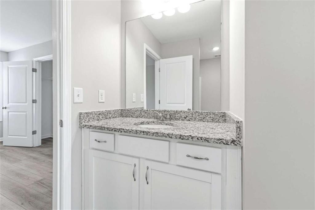 2066 Highway 63 Homer, GA 30547 - Photo 36 of 65 a bathroom with a granite countertop sink and a mirror