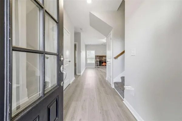 a view of empty room with a fireplace and wooden floor