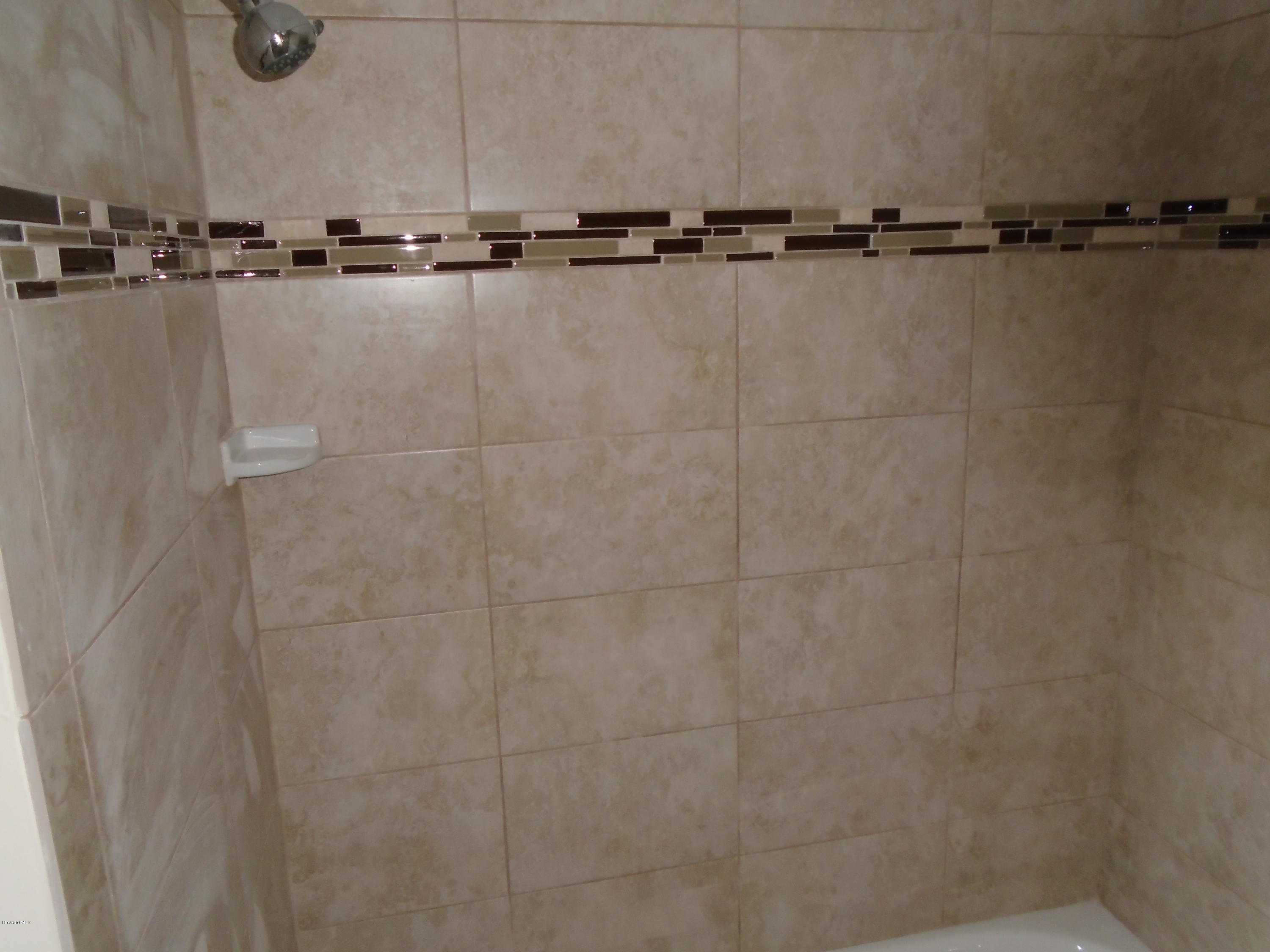 2364 Golfwood Road Melbourne, FL 32935 - Photo 12 of 13 TILE IN HALL BATH