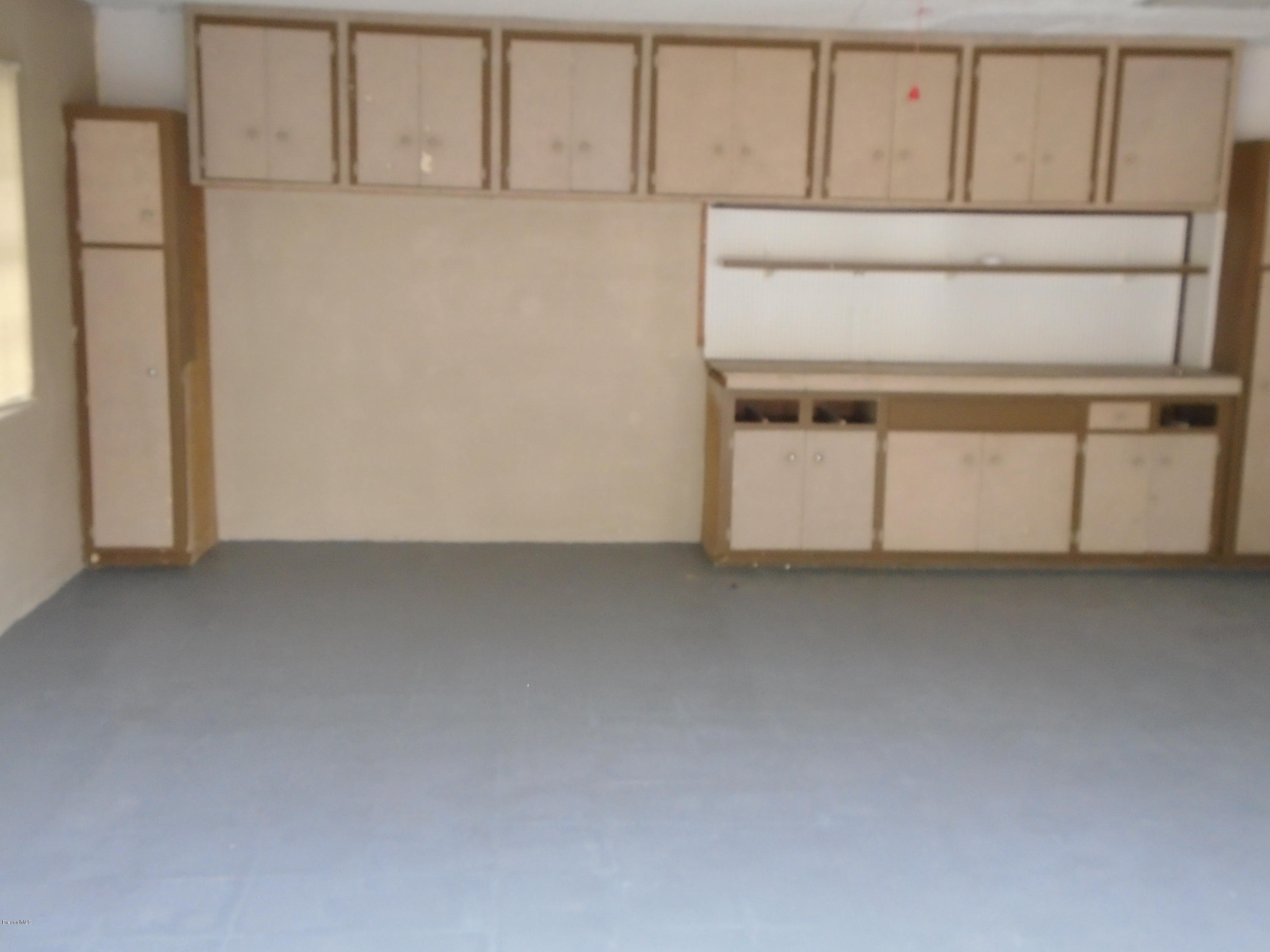 2364 Golfwood Road Melbourne, FL 32935 - Photo 7 of 13 GARAGE WITH CABINETS