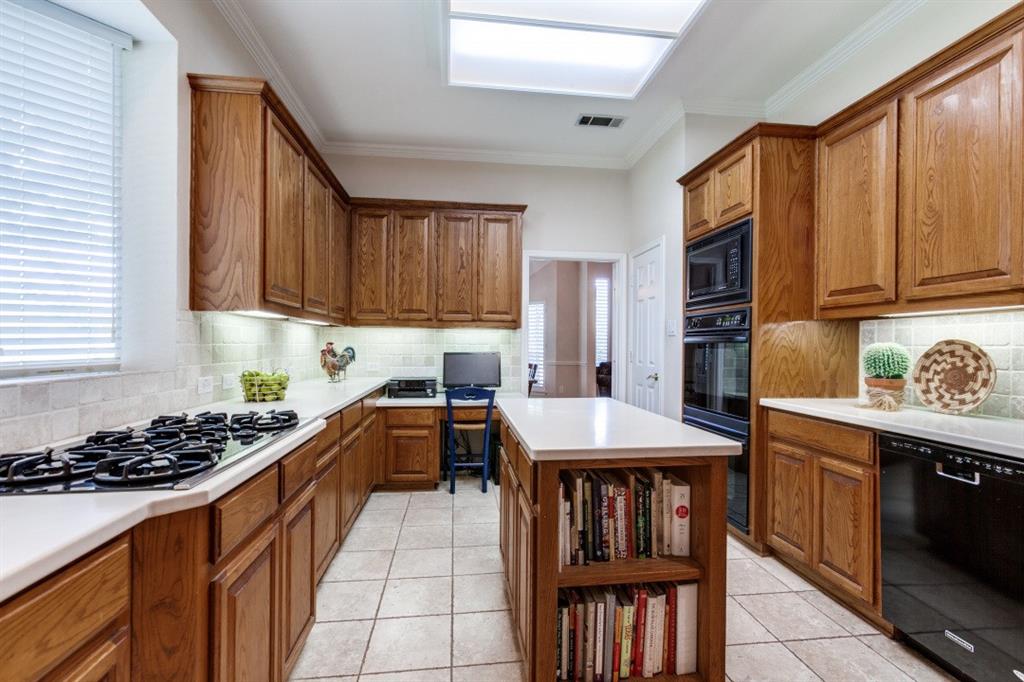 3400 Springbranch Drive Richardson, TX 75082 - Photo 13 of 37 a kitchen with stainless steel appliances granite countertop a stove top oven a sink dishwasher and cabinets with wooden floor