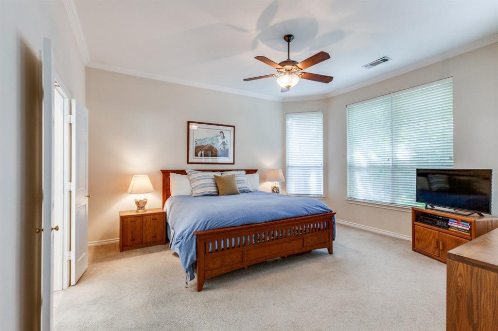 3400 Springbranch Drive Richardson, TX 75082 - Photo 18 of 37 a spacious bedroom with a bed and a flat screen tv