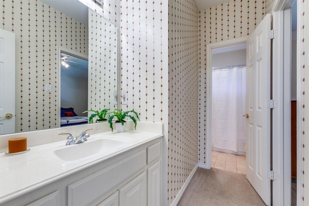 3400 Springbranch Drive Richardson, TX 75082 - Photo 25 of 37 a bathroom with a sink and a mirror