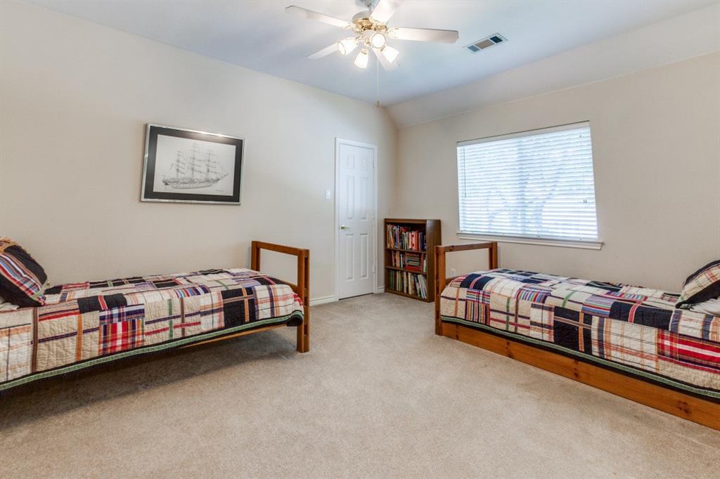 3400 Springbranch Drive Richardson, TX 75082 - Photo 26 of 37 a bedroom with a bed and a chandelier