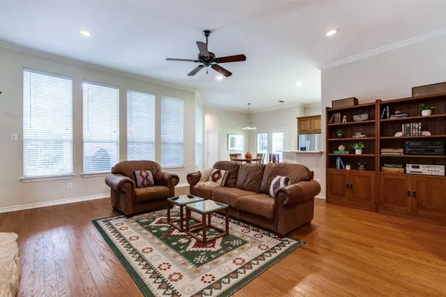 a living room with furniture and a book shelf