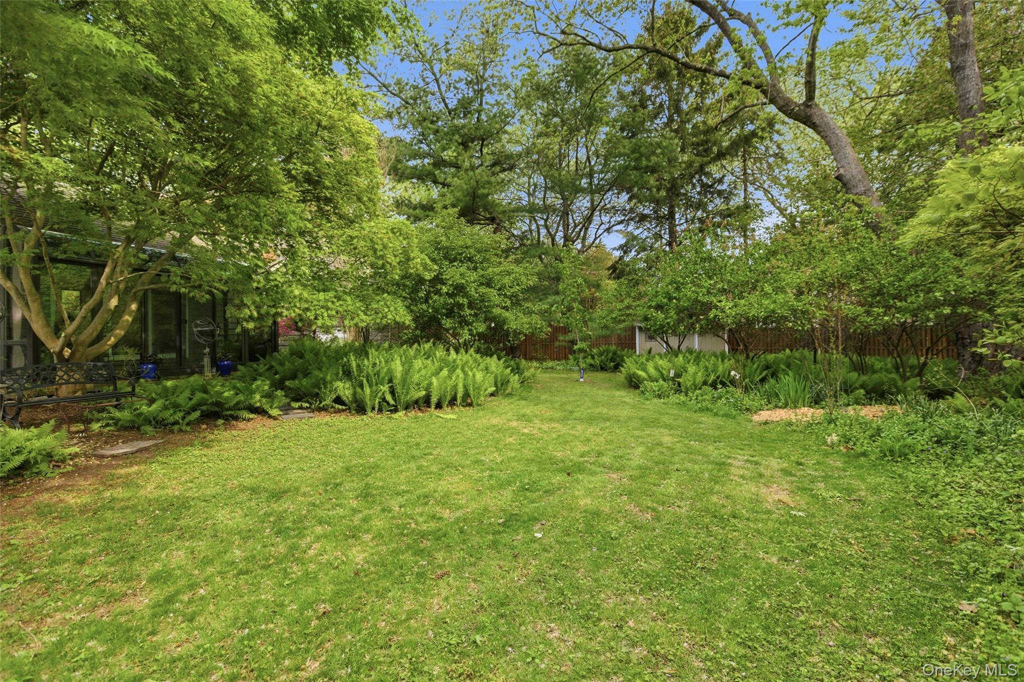 7 Gun Path Setauket, NY 11733 - Photo 3 of 34 a view of a big yard with plants and large trees