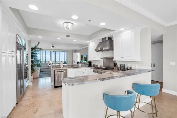 a kitchen with stainless steel appliances kitchen island granite countertop a sink and cabinets