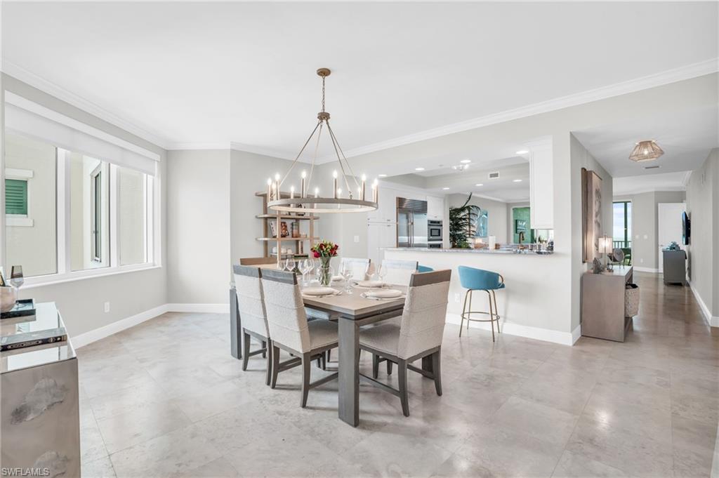 265 Indies Way, Unit 1404 Naples, FL 34110 - Photo 15 of 43 a view of a dining room and livingroom with furniture wooden floor a chandelier