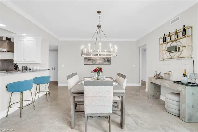 a view of a dining room with furniture and chandelier