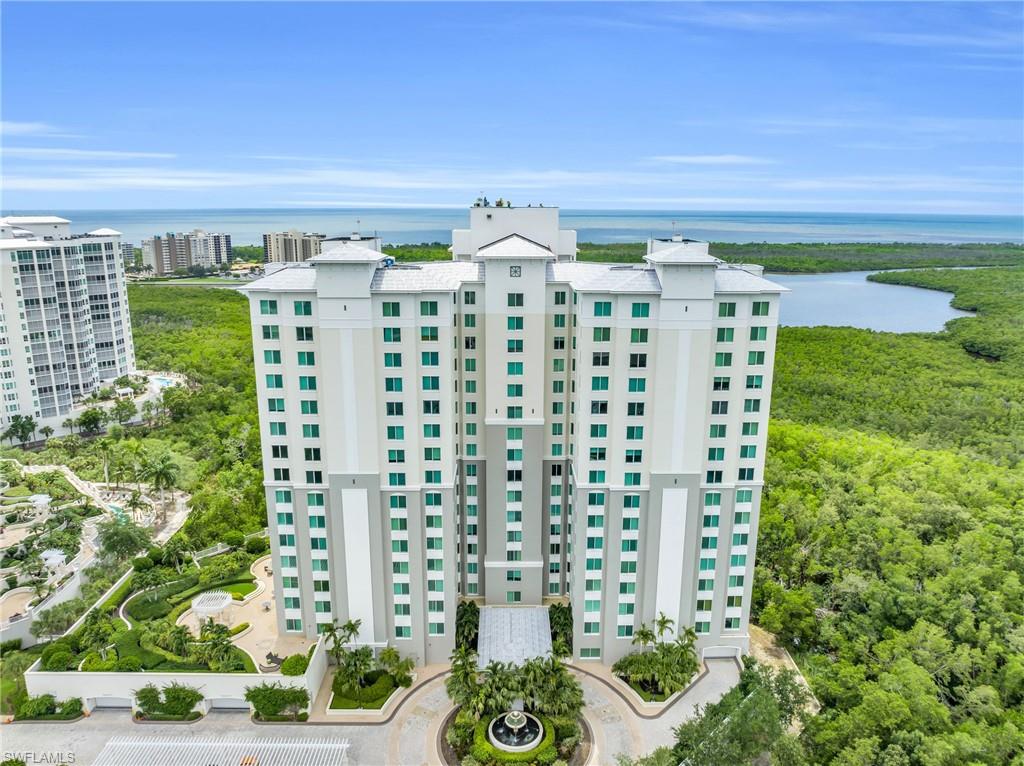 265 Indies Way, Unit 1404 Naples, FL 34110 - Photo 2 of 42 a front view of a building with garden