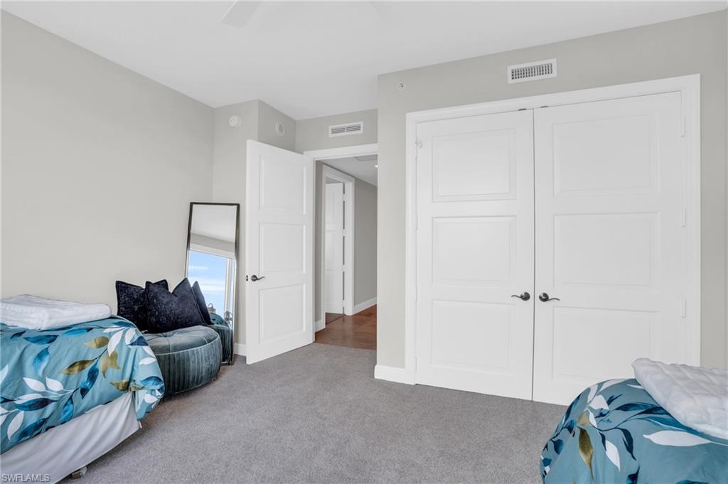 265 Indies Way, Unit 1404 Naples, FL 34110 - Photo 21 of 42 a bedroom with a bed and a window