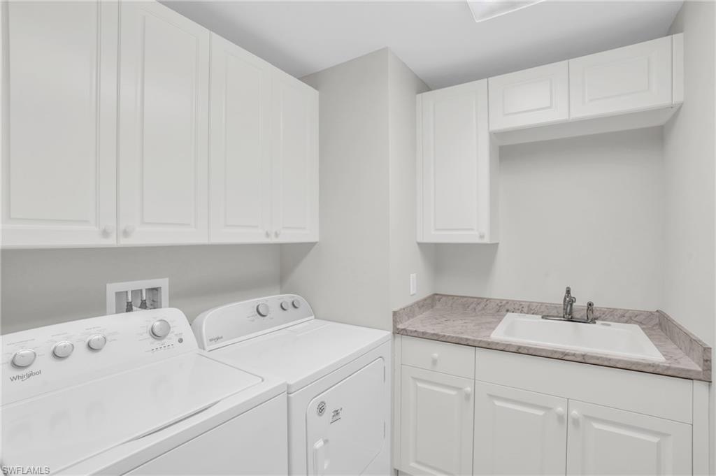 265 Indies Way, Unit 1404 Naples, FL 34110 - Photo 23 of 43 a utility room with sink dryer and cabinets