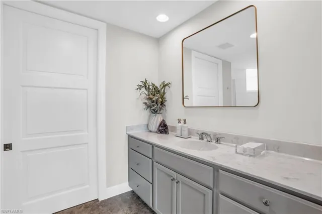 a bathroom with a double vanity sink and a mirror