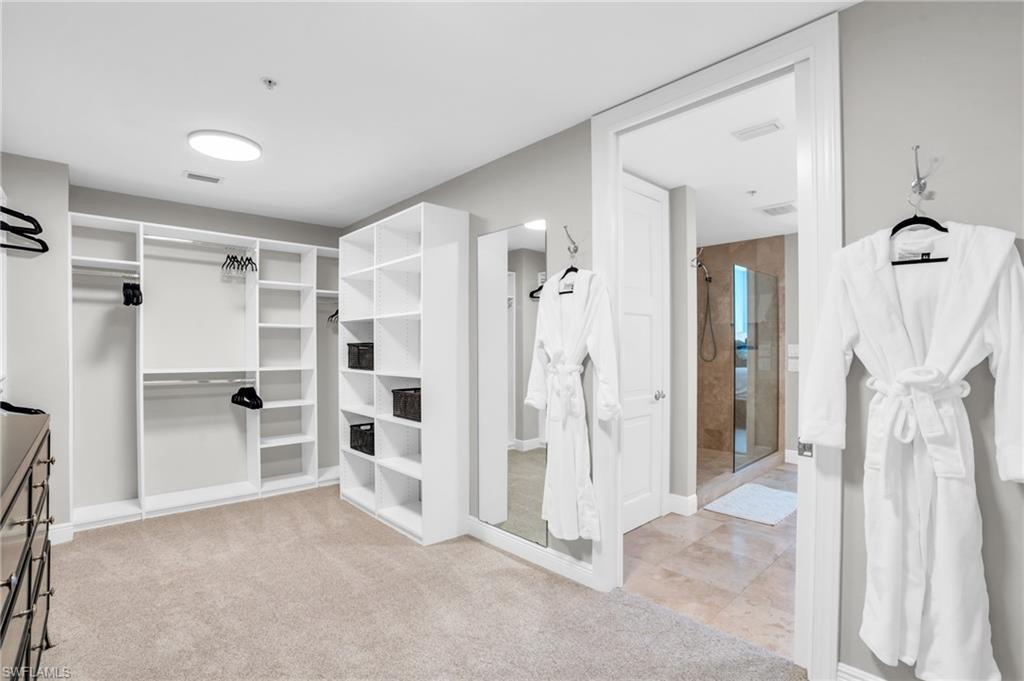 265 Indies Way, Unit 1404 Naples, FL 34110 - Photo 30 of 43 a view of a bathroom with a tub and a shower