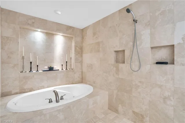 a bathroom with a tub and a shower